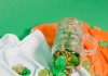 glass with coins on irish flag